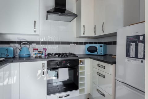 Kitchen or kitchenette, oven, stove, toaster, washing machine