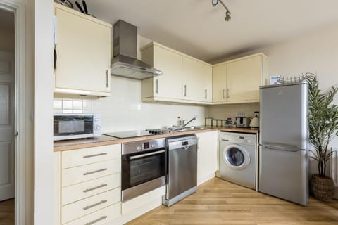 Kitchen or kitchenette, dishwasher, oven, stove, toaster, washing machine, dryer