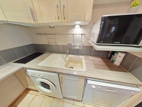 Kitchen or kitchenette, dishwasher, oven, stove, washing machine