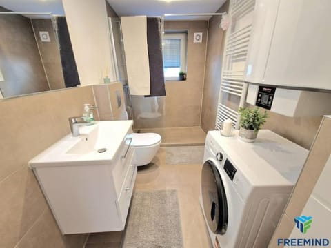 Toilet, Bathroom, towels, washing machine, dryer