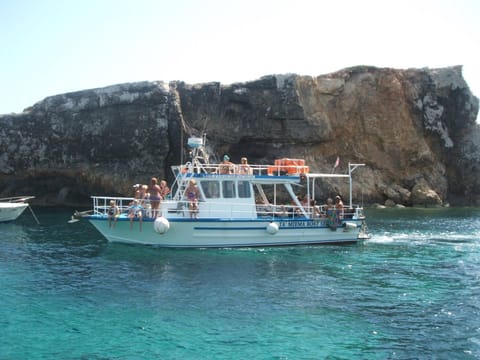 Comino Gozo Private Boat Trips Charters Docked boat in Malta