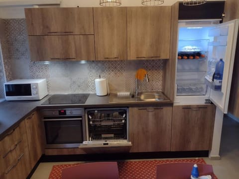 Kitchen or kitchenette, dishwasher, oven, stove