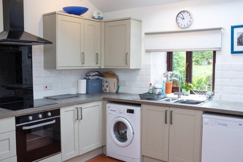 Kitchen or kitchenette, dishwasher, oven, stove, washing machine