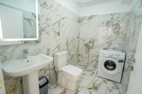 Toilet, towels, washing machine, dryer