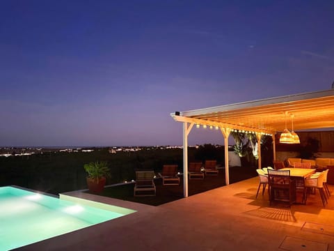 Property building, Patio, Night, View (from property/room), Balcony/Terrace, Dining area, Pool view, Swimming pool, sunbed