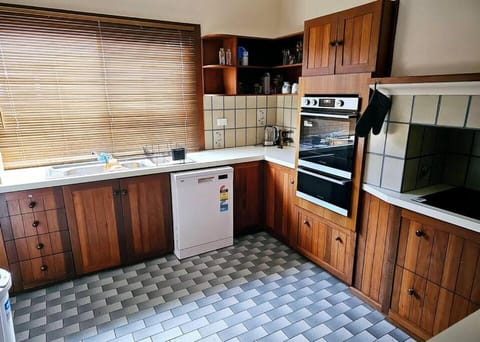 Kitchen or kitchenette, dishwasher, oven, stove, toaster