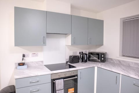 Kitchen or kitchenette, dishwasher, microwave, stove, toaster