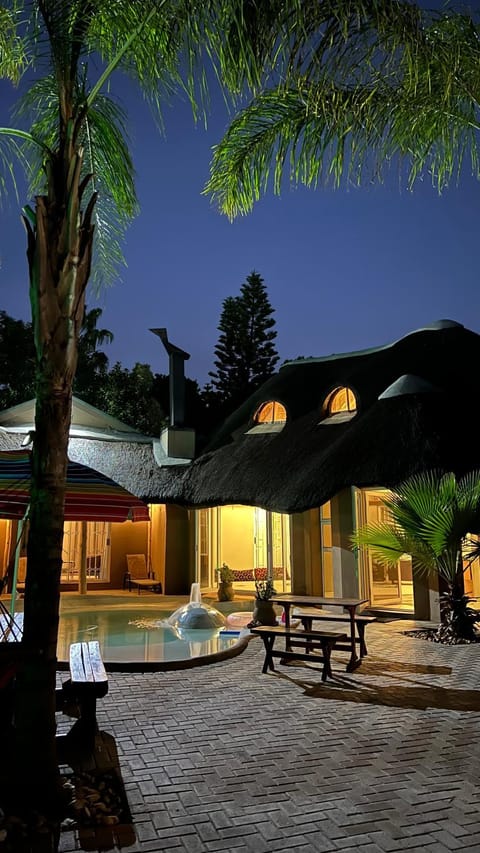 Property building, Patio, Night, Pool view, Swimming pool, Swimming pool, sunbed