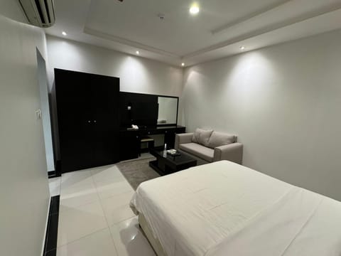 Bed, TV and multimedia, Living room, Seating area, Bedroom