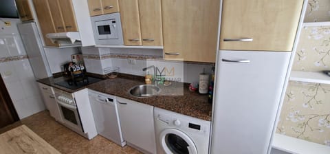 Kitchen or kitchenette, dishwasher, oven, stove, washing machine