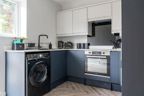 Kitchen or kitchenette, dishwasher, oven, stove, toaster, washing machine, dryer