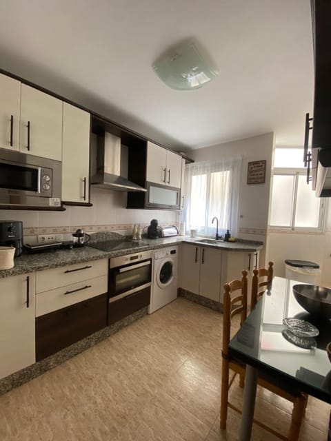 Kitchen or kitchenette, oven, stove, washing machine