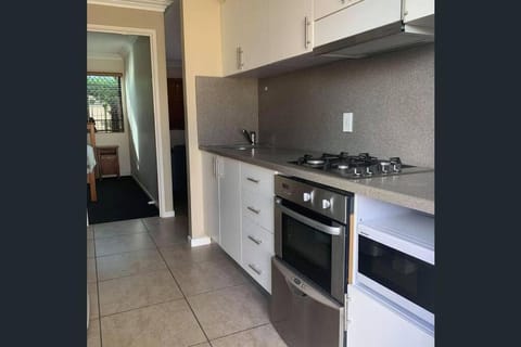 Kitchen or kitchenette, dishwasher, oven, stove