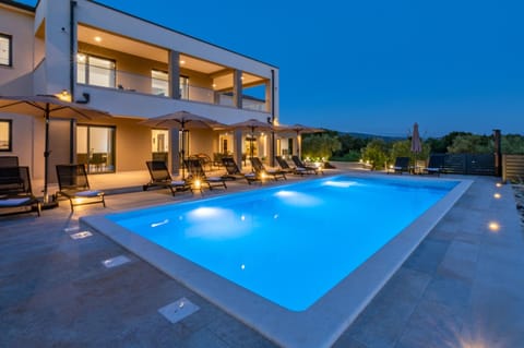 Property building, Patio, Night, Pool view, Swimming pool, sunbed