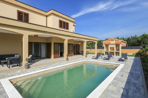 Property building, Patio, Pool view, Swimming pool, sunbed