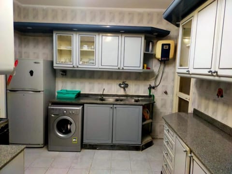 Kitchen or kitchenette, oven, stove, washing machine, dryer