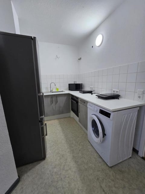 Kitchen or kitchenette, microwave, oven, stove, washing machine