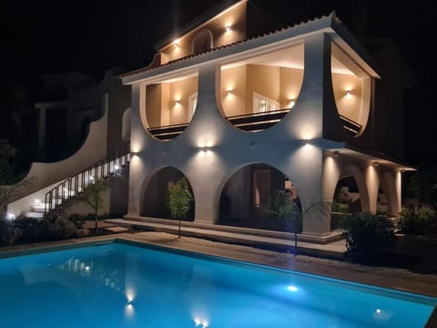 Property building, Patio, Night, Pool view, Swimming pool