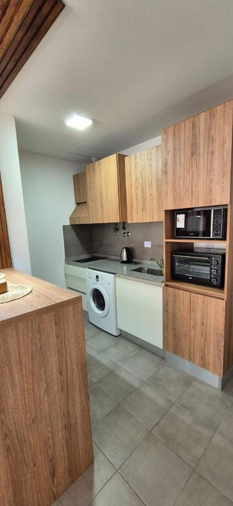 Kitchen or kitchenette, oven, stove, washing machine