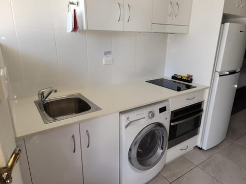 Kitchen or kitchenette, washing machine