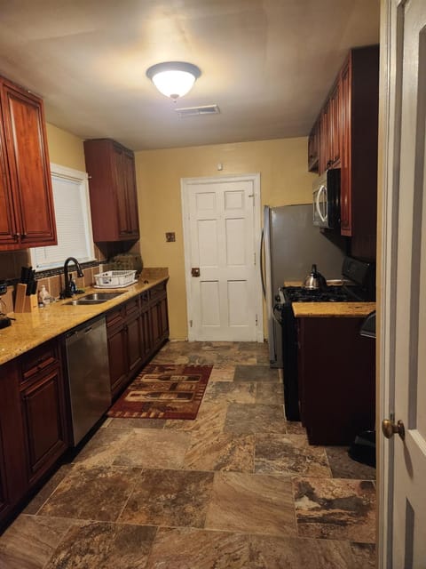 Kitchen or kitchenette, dishwasher, oven, stove