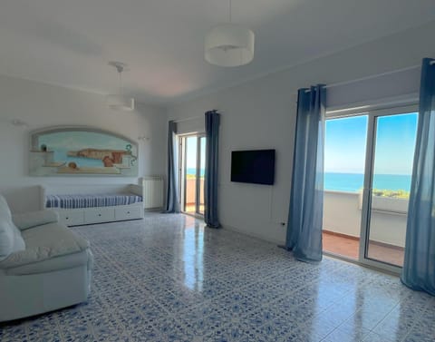 Communal lounge/ TV room, Bed, TV and multimedia, Living room, Photo of the whole room, Decorative detail, Decorative detail, Seating area, Bedroom, Sea view