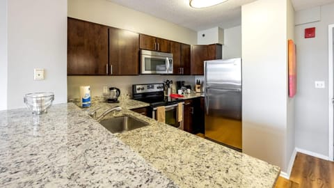 Kitchen or kitchenette, dishwasher, oven, stove