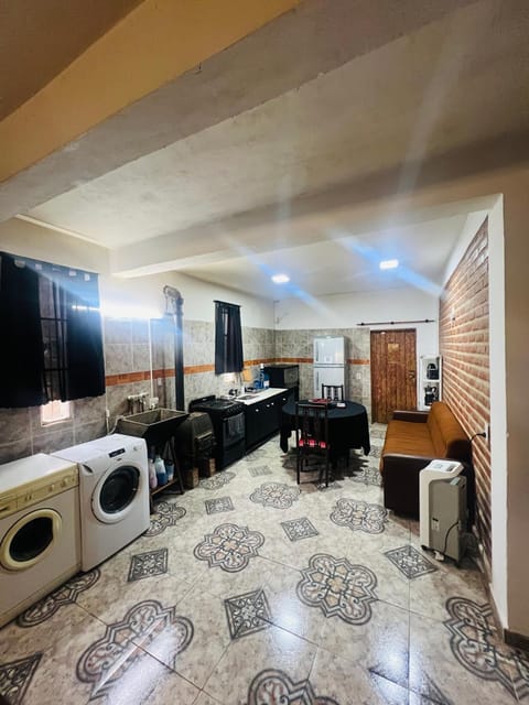 Kitchen or kitchenette, fireplace, washing machine