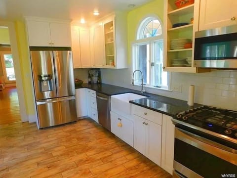 Kitchen or kitchenette, dishwasher, oven, stove