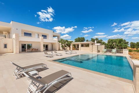 Property building, Patio, Pool view, Swimming pool, sunbed