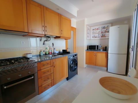 Kitchen or kitchenette, microwave, oven, stove