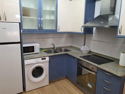 Kitchen or kitchenette, oven, stove, washing machine