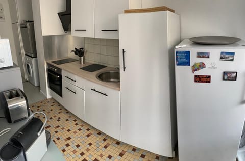 Kitchen or kitchenette, dishwasher, oven, stove