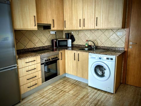 Kitchen or kitchenette, oven, stove, toaster, washing machine