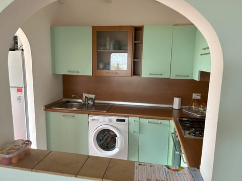 Kitchen or kitchenette, stove, washing machine