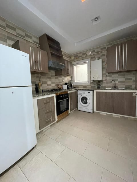 Kitchen or kitchenette, oven, stove, toaster, washing machine