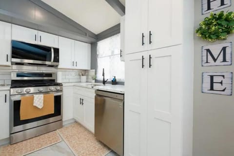 Kitchen or kitchenette, dishwasher, oven, stove