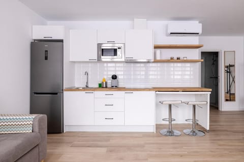 Kitchen or kitchenette, stove, air conditioner