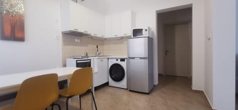 Kitchen or kitchenette, Dining area, oven, stove, washing machine, dryer