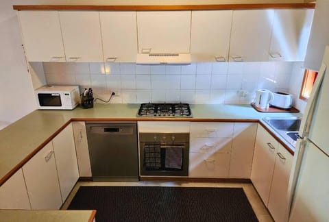 Kitchen or kitchenette, dishwasher, stove, toaster