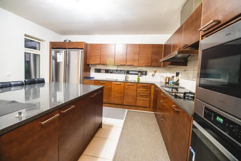 Kitchen or kitchenette, dishwasher, oven, stove