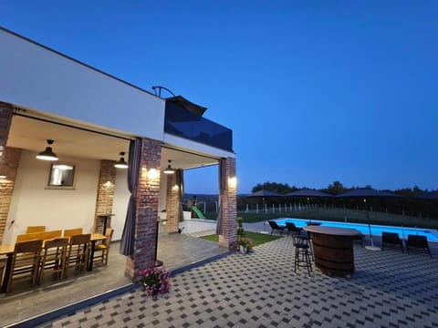 Property building, Patio, Night, Natural landscape, Pool view, Swimming pool, sunbed