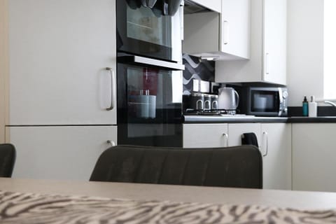 Toilet, Kitchen or kitchenette, microwave, oven, stove, stove, toaster, towels, kitchen