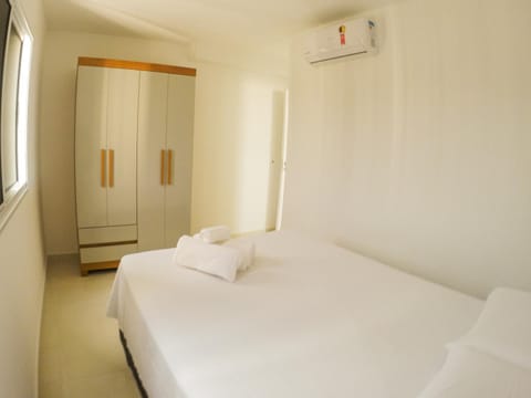 Bed, towels, wardrobe, air conditioner