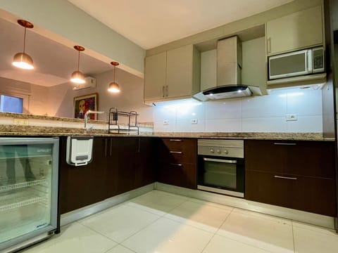 Kitchen or kitchenette, microwave, oven, stove