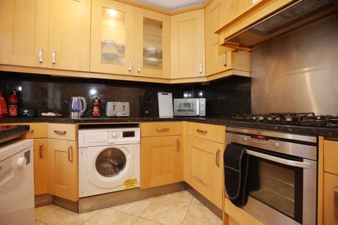 Kitchen or kitchenette, dishwasher, oven, stove, toaster, washing machine