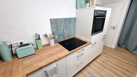 Kitchen or kitchenette, dishwasher, oven, stove