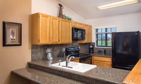 Kitchen or kitchenette, dishwasher, oven, stove