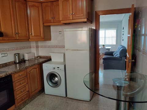 Kitchen or kitchenette, dishwasher, oven, stove, toaster, washing machine