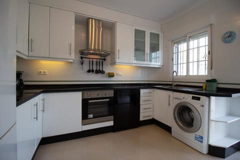 Kitchen or kitchenette, dishwasher, oven, stove, toaster, washing machine